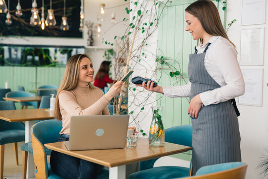 Woman Paying Contactless With Smartphone In Cafeteria