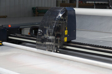 Industrial garment factory, a special Laser Cutting Fabric cuts out certain textile pieces.