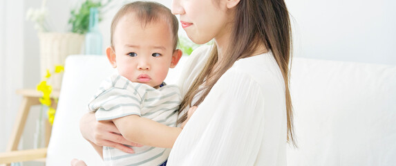 赤ちゃんを抱っこする母親　リビング