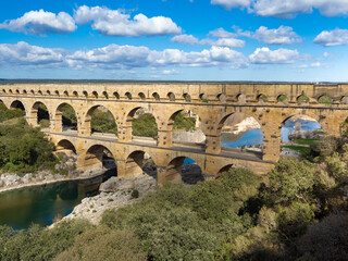 Fototapeta premium The magnificent Pont du Gard, an ancient Roman aqueduct bridge, Vers-Pont-du-Gard in southern France. Built in the first century AD to carry water to the Roman colony of Nemausus (Nîmes)