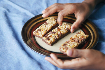 Almond , Raisin and oat protein bars on table 