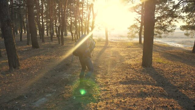concept sciatic rheumatism back pain the medicine. man traveler tourist with a backpack pulled his back tired face pain. hiker concept travel difficulties lifestyle tourism sunlight sunset