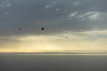 Fototapeta na wymiar Sunrise balloons in flight over the north west Saudi Arabian desert area of Al Ula
