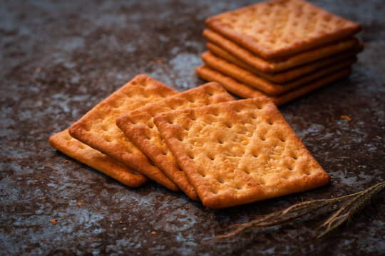 close up cream crackers on dirty metal sheet backdrop. delicious crackers snack.
