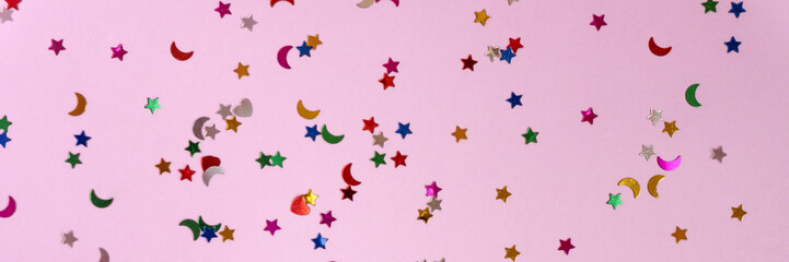 Banne rof Festive pink background with many colorful stars and moons. Christmas, New Year or Birthday theme concept. Backdrop for your banner or web design. Backplate for happy holidays presentation
