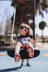 Obraz premium Kissimmee Lakefront Park Grassy waterfront park with walking paths, a fishing pier, picnic pavilions, and a shaded playground. children's playgrounds, splash pad