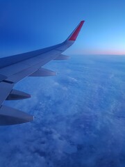 Airplane wing in the blue sky