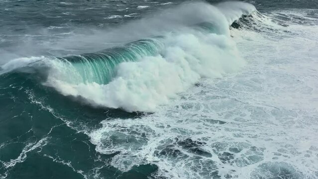 Flying over big storm ocean wave. Pacific Ocean surf crashing. Aerial slow motion shot
