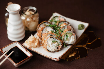 Large rolls with avocado and salmon in the restaurant