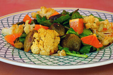 Winter salad with fresh kale, orange, roasted cauliflower, Brussels sprouts and pumpkin seeds