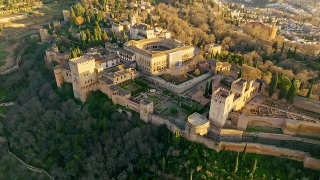 Aerial view of Alhambra Palace in Granada, Andalusia, Spain. Flying over famous Alhambra palace and fortress at sunset. 4K
