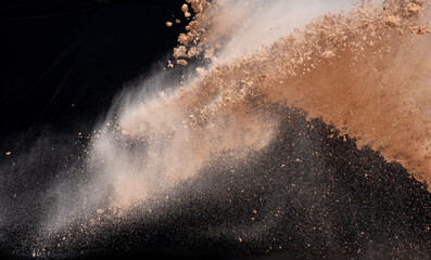 Soil explosion isolated on black background