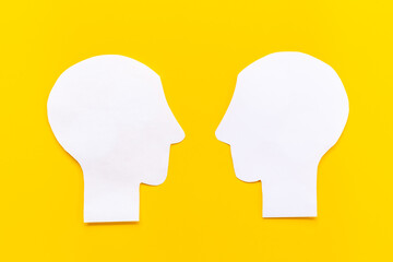 Human communication concept with two paper human heads
