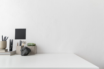 Home office, creative desk with office supplies and beige wall...	