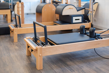 Fitness pilates stretch tables and other exercise equipment in gym. High quality photo