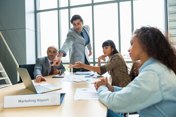 Young creative managers team working on laptop with new project in modern office.