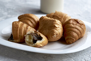 a plate of croissants and a cup of coffee on the table