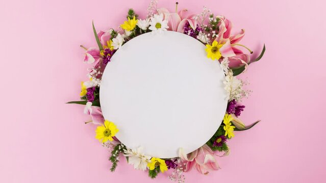 flowers and leaves surround the white circle