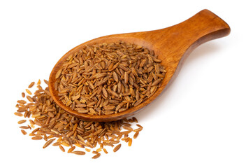 Roasted cumin seeds in the wooden spoon, isolated on the white background.