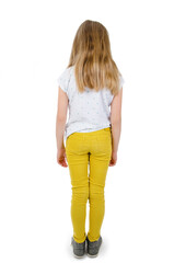 Rear view of modern little girl, standing. Isolated on white background. Back view. Full length of adorable teenage girl standing looking down.
