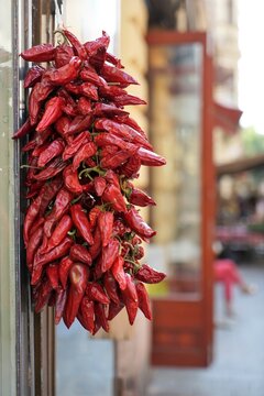 red chili peppers, cayenne pepper hanging on the store wall, a chili ristra, drying chili pepper pods