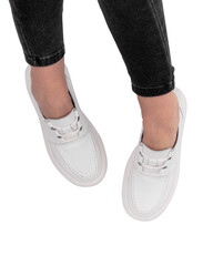 Women's legs in stylish sports shoes on a white background