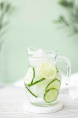 mineral water with cucumber and lemon in a glass jug