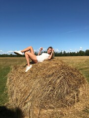 Naklejka na ściany i meble person sitting on hay bale