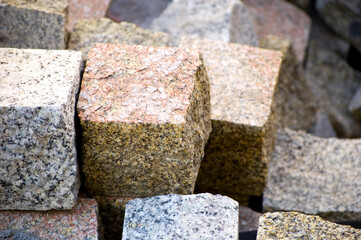 Loose granite pavement sett lying in the street.