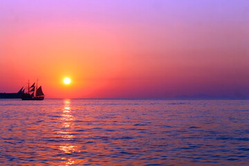 Naklejka na ściany i meble Purple vessel sunset on the infinite ocean with the reflections on the water