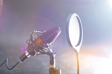 Close-up of a professional microphone with a pop filter in front of it. Desktop microphone for...