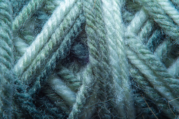Close-up of threads from a mixture of acrylic and wool for knitting. Background in soft focus at high magnification. The structure of the threads close-up.