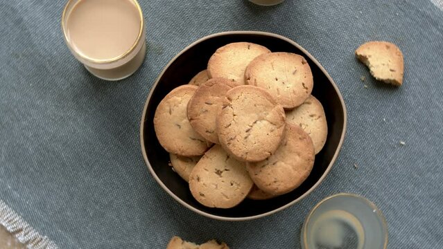 Home-baked biscuits jeera cumin biscuits and masala chai. Top view, table spin.