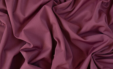 Texture of pink fabric. Background with folds. Close-up.