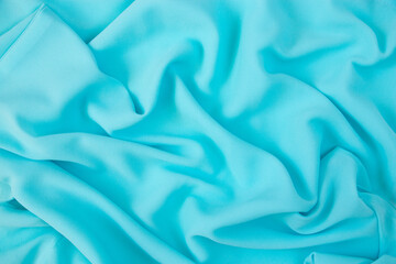 Blue fabric texture. Background with folds. Close-up.