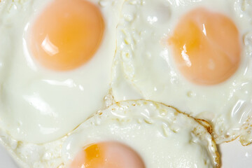 Close-up scrambled eggs. Three fried eggs on a plate. Quick and tasty breakfast