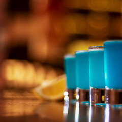 blue kamikaze shots on wooden table closeup square