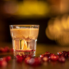 baileys shot with grenadine seeds on wooden table square