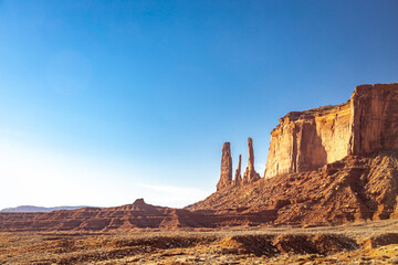 Classic southwest desert landscape under a blue sky and bright sun in Monument Valley in Arizona and Utah.