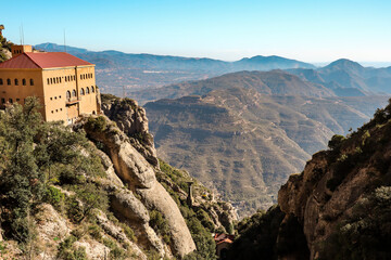 Building on the Edge of the Rock Mountain in Montserrat. Beautiful Scene of Architecture in Nature in Spain.