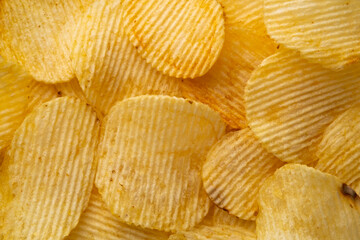 Close up Fried wavy potato chips snack background