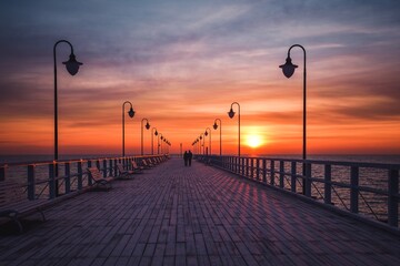 Beautiful morning seaside landscape. Wooden pier with a colorful sky in Gdynia, Poland.