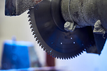 Cutting aluminium billet with machine.  .Circular milling machine cutting metal profile..Steel industry.