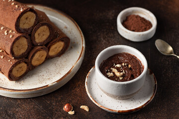 Vegan chocolate spread made from hazelnuts, cocoa and plant based milk. Healthy breakfast with saturated fats. dark background