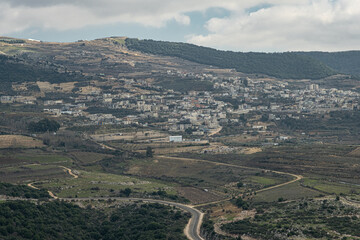 Fototapeta na wymiar View of Ein-Qiniyye, a Druze village located on the southern foothills of Mount Hermon as seen from Nimrod Crusader Castle southern wall, Golan Heights, Israel.