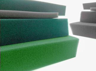 pile of thick green and gray sponge foam material on a white background - obrazy, fototapety, plakaty