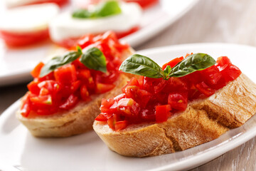 Fototapeta na wymiar Italian appetizer bruschetta with fresh tomatoes on a plate