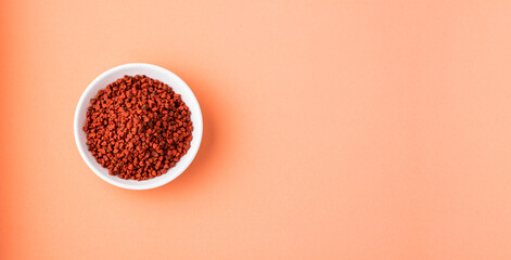 Annatto organic seeds in the wooden bowl - Bixa Orellana