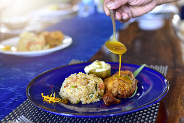 African national dish grilled chicken With fried rice and flavored water. Healthy lifestyle eating. on a white plate. selective focus