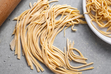 Raw homemade noodles, egg noodles. Home cooking concept.